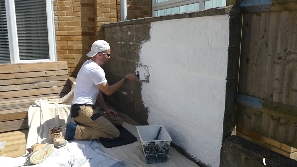 Applying Emperor Masonry Paint to exterior wall